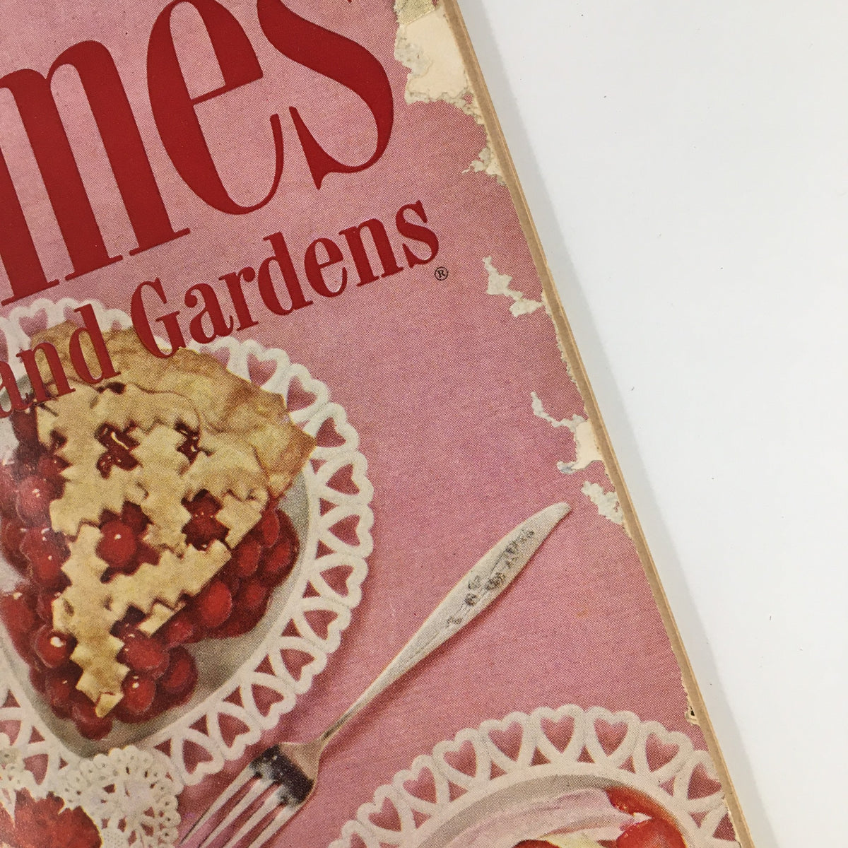 Close-up of the title 'Better Homes & Gardens' on the cover of the February 1959 issue, displaying a pink background and intricate dessert illustrations, highlighting its vintage charm.