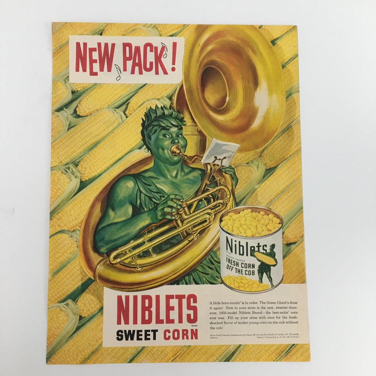 1950 Niblets Brand Vacuum Packed Fresh Corn Off The Cob Vintage Print Ad featuring a green character playing a tuba, emphasizing fresh corn.
