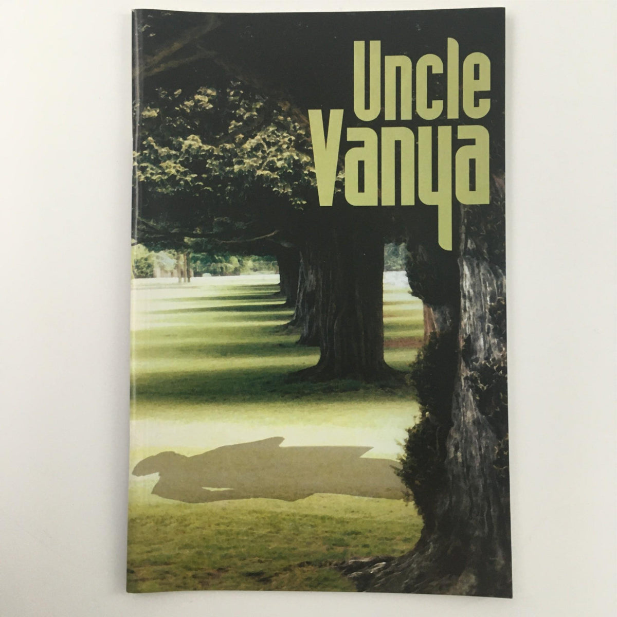 Cover of 'Uncle Vanya' by Anton Chekhov, directed by Emily Mann, depicting a serene tree-lined pathway at McCarter Theatre Center.