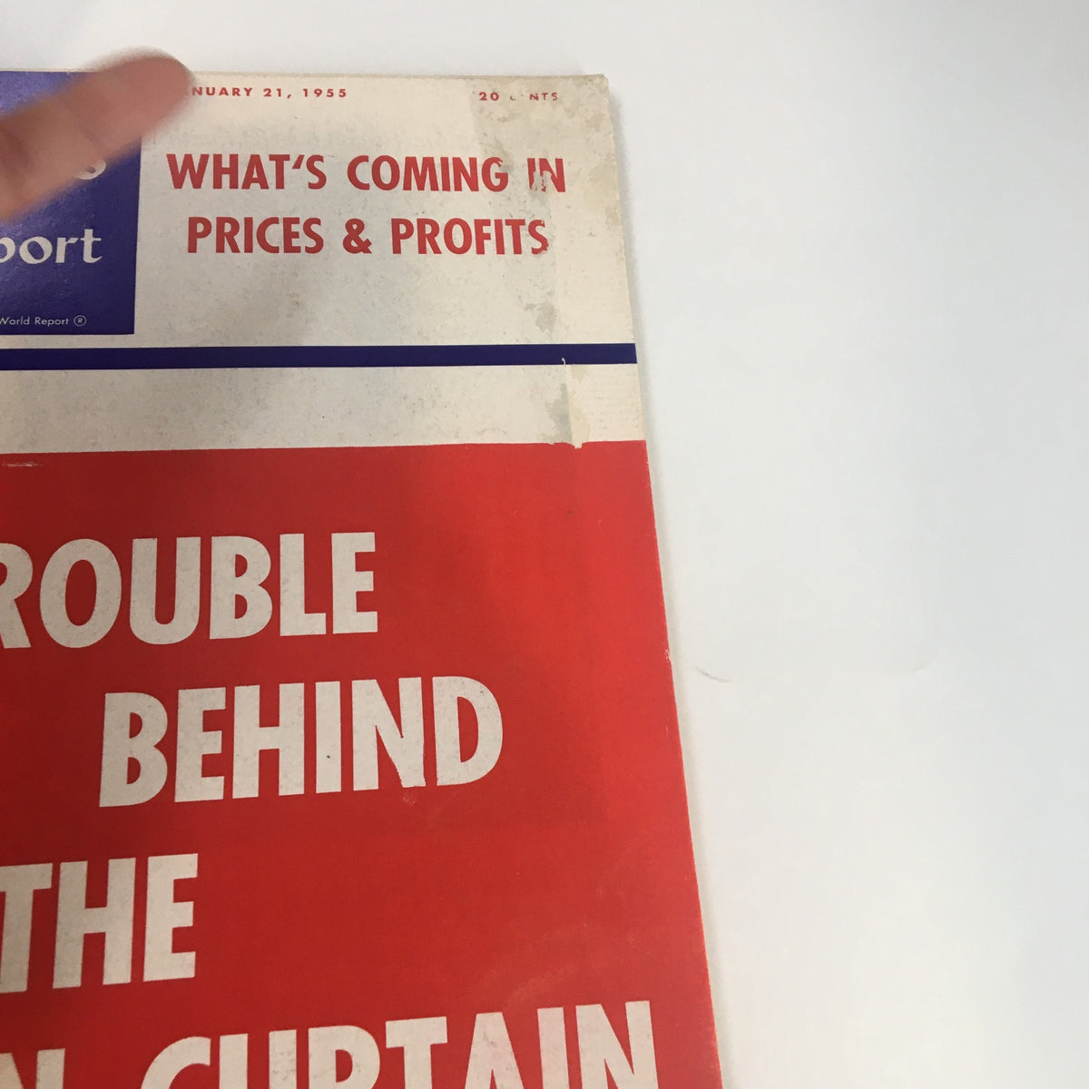 Close-up view of the cover of US News & World Report Magazine January 21 1955, displaying the title 'Trouble Behind The Iron Curtain' and information on prices and profits.