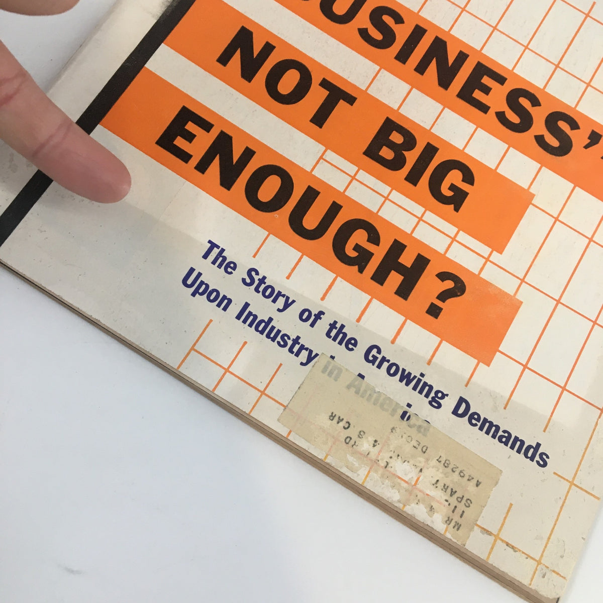 Close-up view of the cover of US News & World Report Magazine March 30, 1959 highlighting the question 'Big Business Not Big Enough?' along with the magazine's title and a hand pointing to the text.