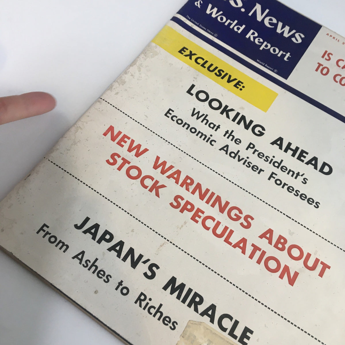 Close-up of the cover of US News & World Report Magazine April 20, 1959, highlighting the article 'Japan's Miracle: From Ashes to Riches' and other features on economic insights.