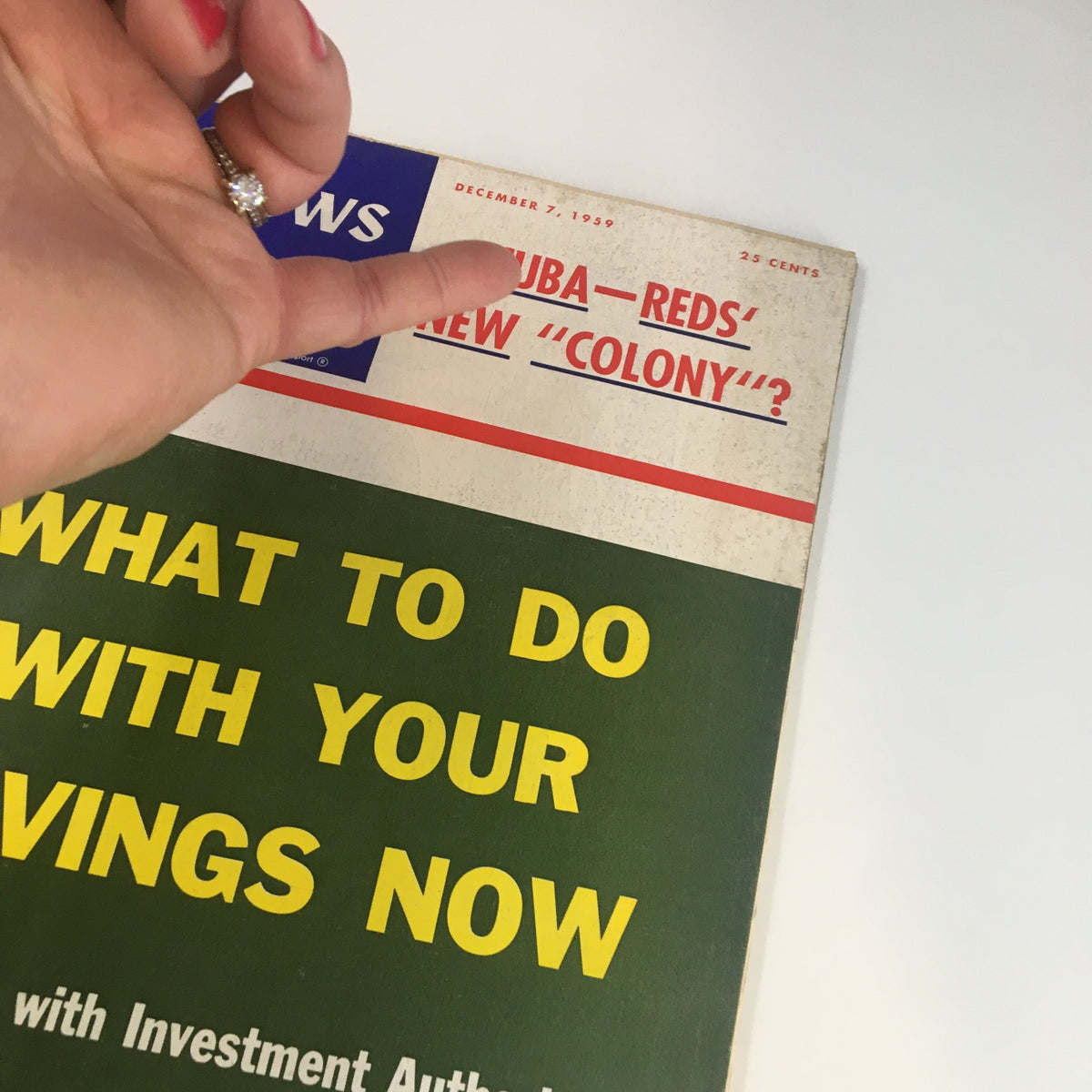 Detailed view of the US News & World Report Magazine cover from December 7, 1959, highlighting the headline 'What To Do With Your Savings Now' with a hand pointing at the text.
