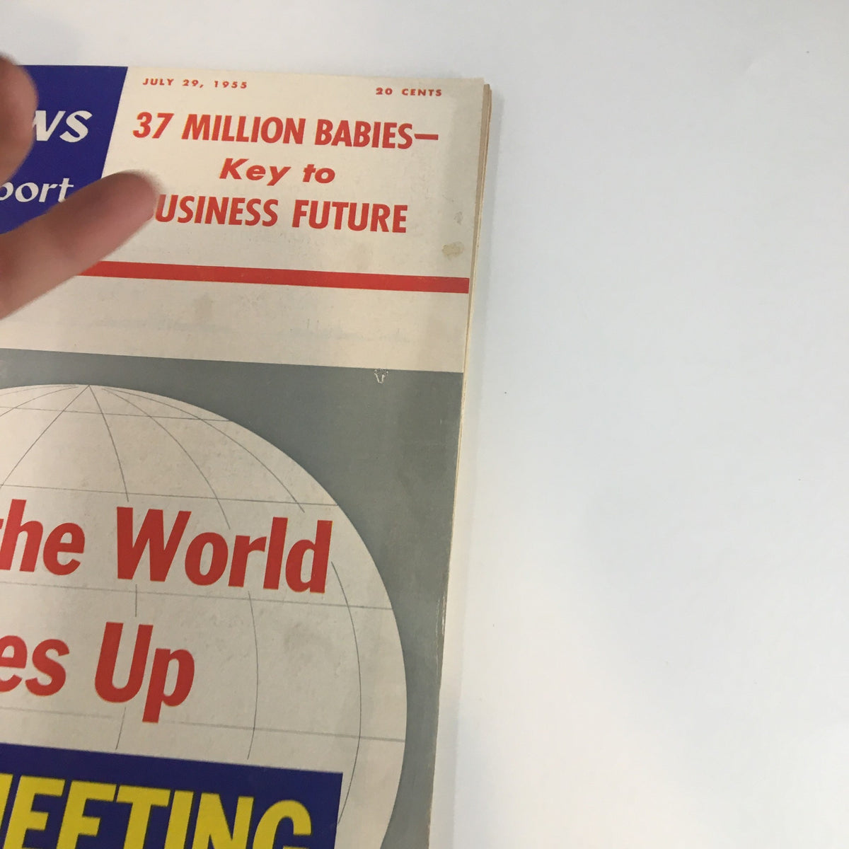 Close-up view of the cover of U.S. News & World Report Magazine from July 29, 1955, highlighting the title 'How the World Sizes Up' and other text related to business and demographics.