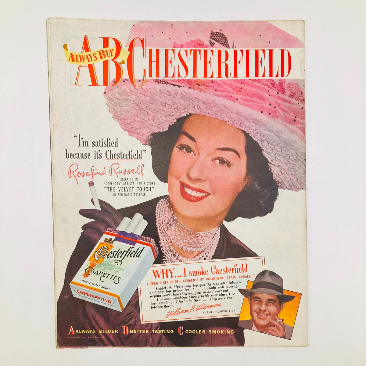 Cover of a Chesterfield cigarette advertisement featuring actress Rosalind Russell, promoting Chesterfield cigarettes with a glamorous portrait, from the Saturday Evening Post Magazine July 3 1948 John Falter Golf Painting Cover.