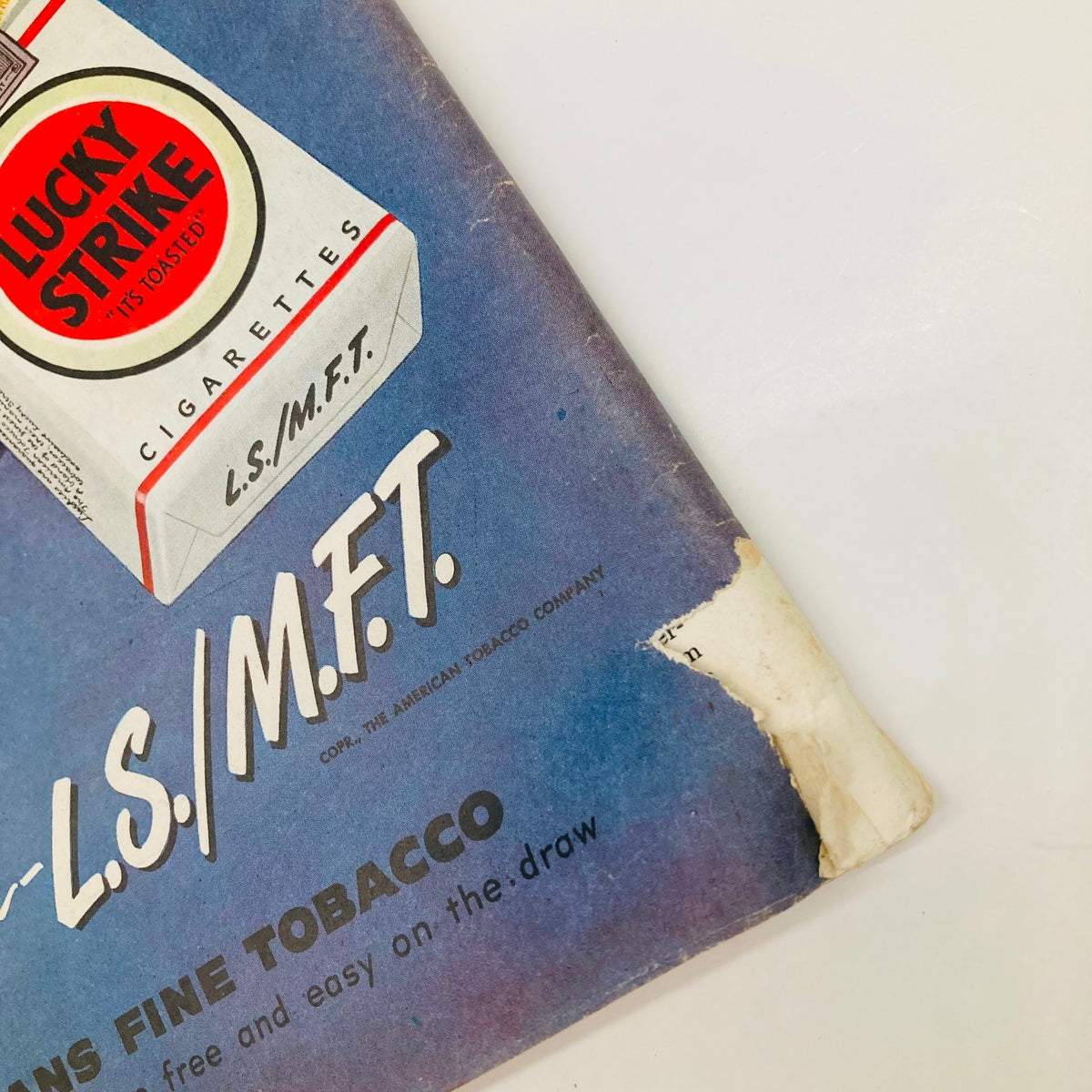 Detail of the Lucky Strike cigarette advertisement on the back cover of the Saturday Evening Post Magazine October 23, 1948, emphasizing the brand's motto 'L.S./M.F.T.' in a colorful background.
