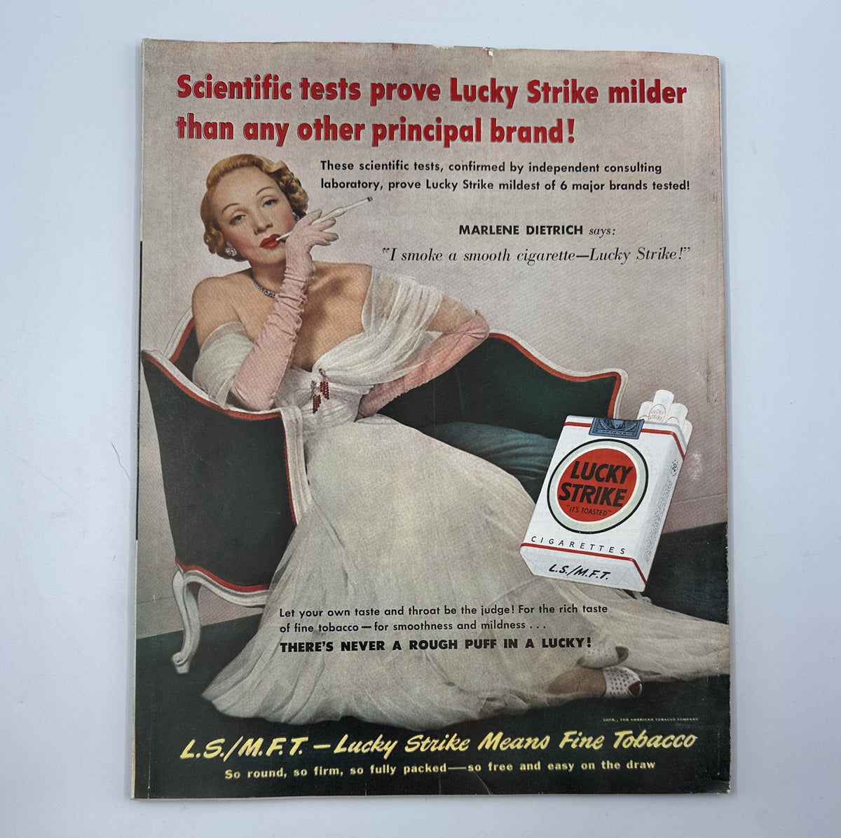 Advertisement for Lucky Strike cigarettes featuring Marlene Dietrich in a glamorous pose with the product, highlighting its milder taste, from the Woman’s Home Companion Magazine June 1950.