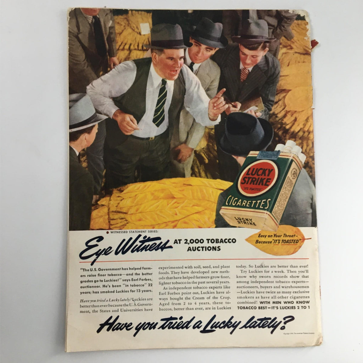 Back cover of Newsweek Magazine from October 9, 1939, featuring an advertisement for Lucky Strike Cigarettes amidst tobacco auction imagery.