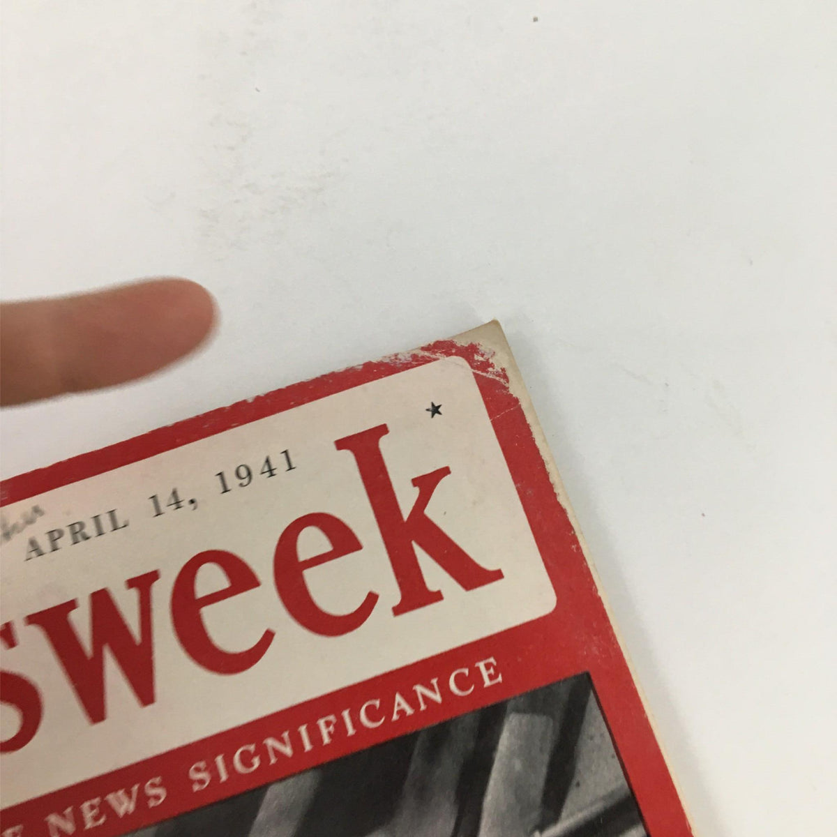 Close-up view of the Newsweek Magazine dated April 14, 1941, highlighting the magazine title with visible wear and tear, underlining its vintage nature. Title: Newsweek Magazine April 14, 1941 Destruction on the March: Nazis Move Again.