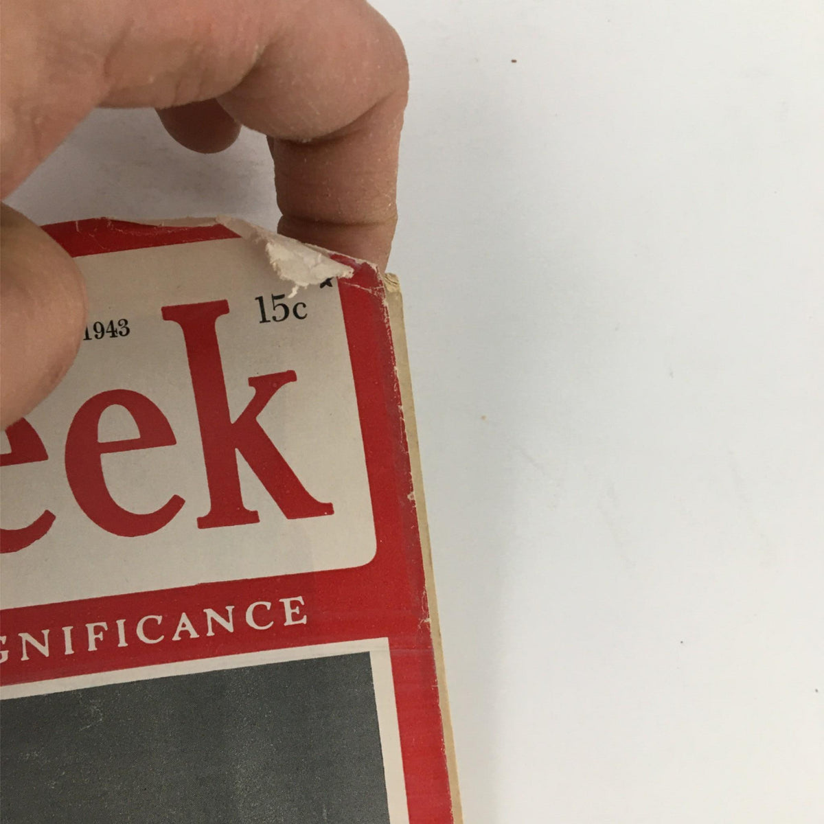 Close-up of the top corner of Newsweek Magazine from March 22, 1943, displaying the magazine title and price of 15 cents, highlighting its vintage condition.
