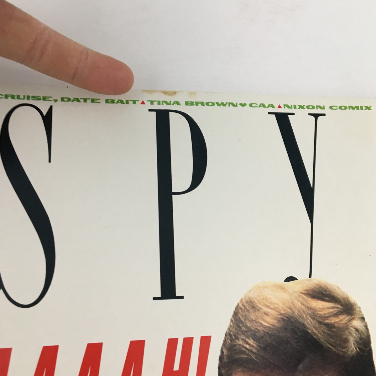 Close-up detail of the title section of Spy Magazine August 1990, highlighting the names Tom Cruise, Date Bait, and Tina Brown.