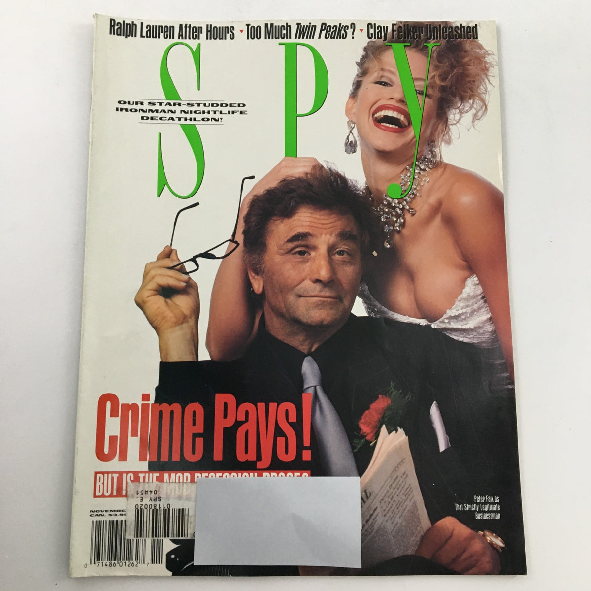 Cover of Spy Magazine November 1990 featuring Peter Falk with glasses and a woman in a revealing outfit, showcasing topics like Ralph Lauren, Twin Peaks, and Clay Felker. Ideal for vintage magazine collectors.