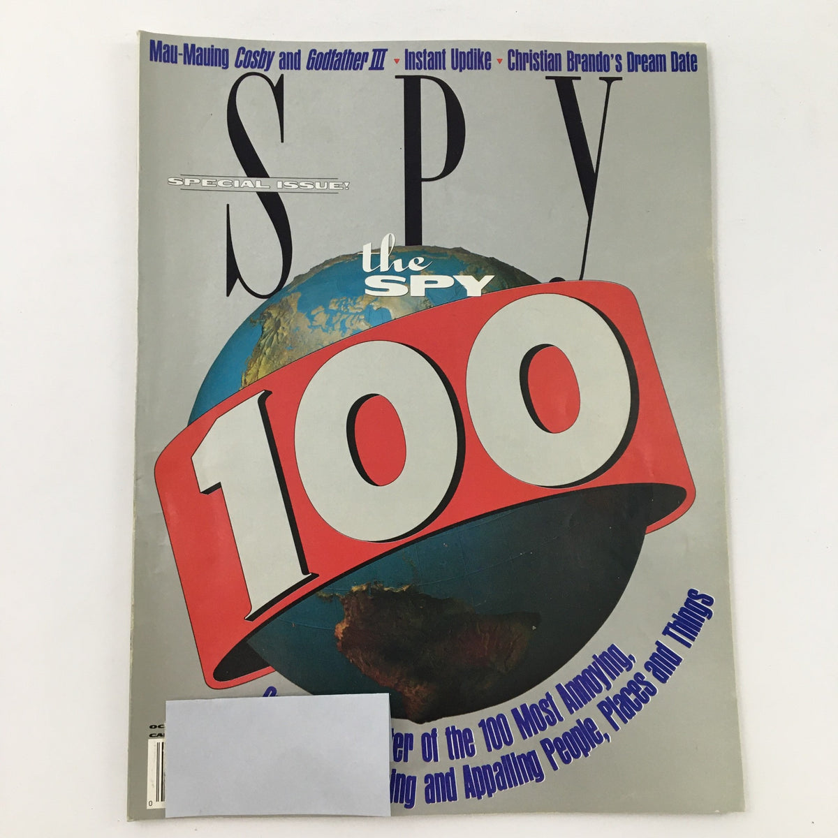 Cover of Spy Magazine October 1990 featuring the title 'Spy 100' with a globe image, highlighting articles on Mau-Mauing Cosby, Godfather III, and Christian Brando.