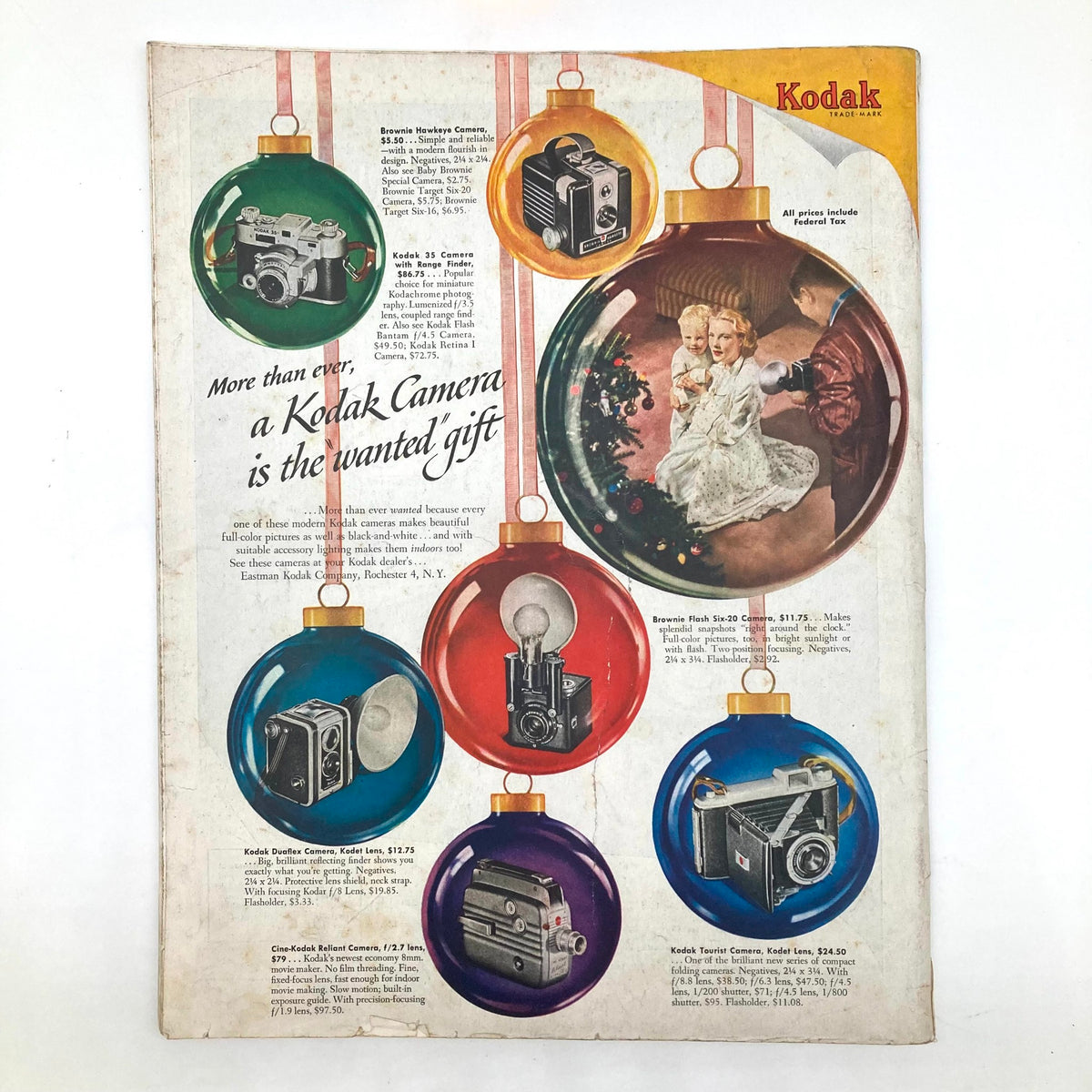 Kodak advertisement from the Saturday Evening Post Magazine December 10 1949, promoting various Kodak cameras as the ideal holiday gift, featuring colorful ornaments and family imagery.