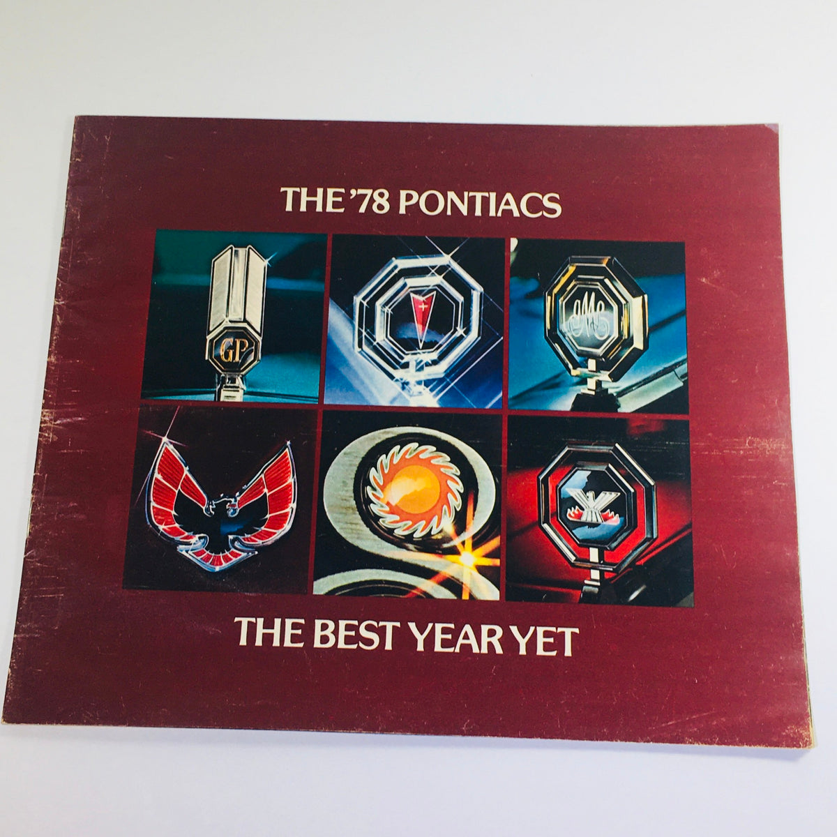 Cover of Vintage 1978 The Pontiacs brochure showcasing the best features with iconic logos and design, titled 'THE BEST YEAR YET'.