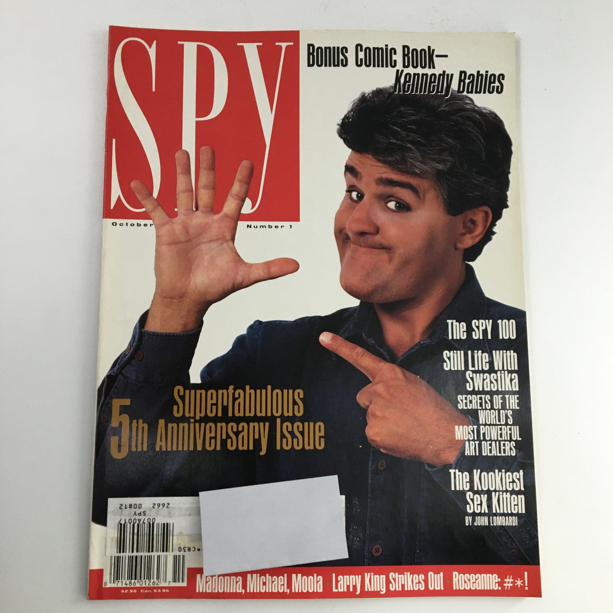 Cover of Spy Magazine October 1991 featuring notable articles including 'Life with Swastika' and appearances by Madonna, Larry King, and Moola. This issue marks the 5th Anniversary of Spy and includes a bonus comic book, showcasing a playful and nostalgic design.