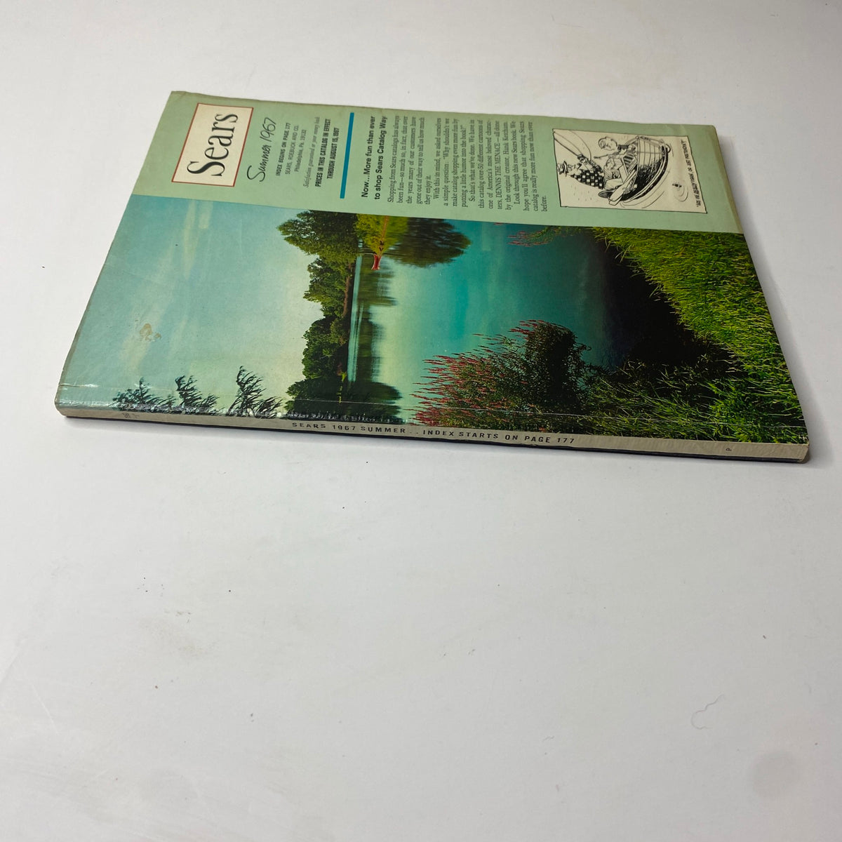 Side view of the 1967 Sears Summer Catalog Way showcasing the same serene lakeside cover as the front, emphasizing its vintage charm.