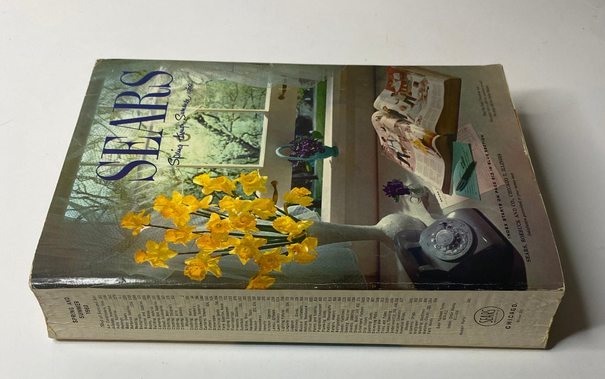 Side view of the 1960 Sears Roebuck and Co. Illinois Spring through Summer Catalog showcasing vibrant flowers and a classic telephone, indicative of the nostalgic style of the 1960s.