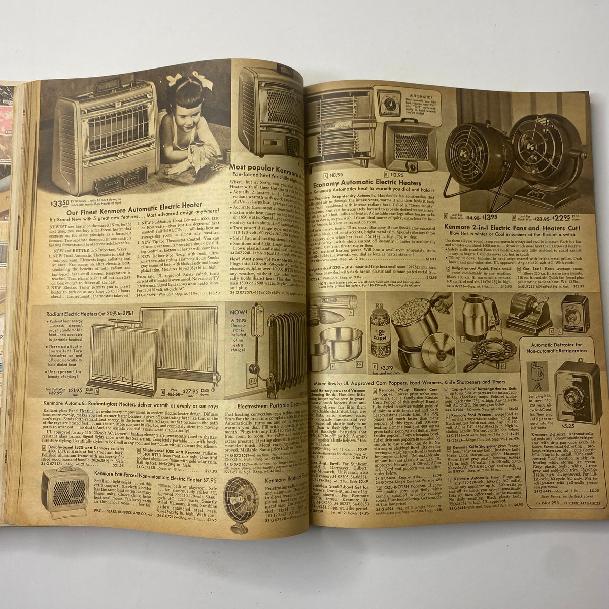 Interior pages of the 1956 Sears Roebuck and Co. Fall and Winter Catalog showcasing Kenmore electric heaters, featuring vintage advertisements and product descriptions.