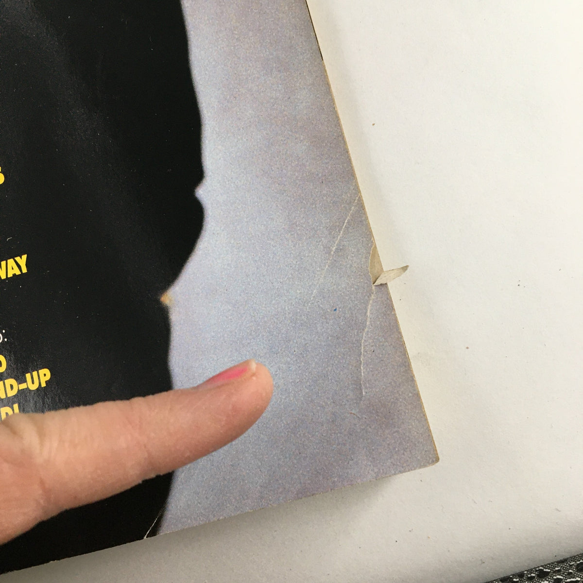 Close-up of the back cover of Keyboard Magazine January 1990, highlighting minor wear with a finger pointing to a crease, relevant to its vintage condition.