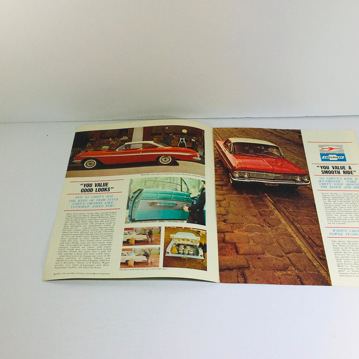 1961 Chevrolet Chevy Sedan 61PC-3 Dealership Car Auto Brochure Catalog showcasing a vintage advertisement with images of a red Chevy car and a detailed interior display.