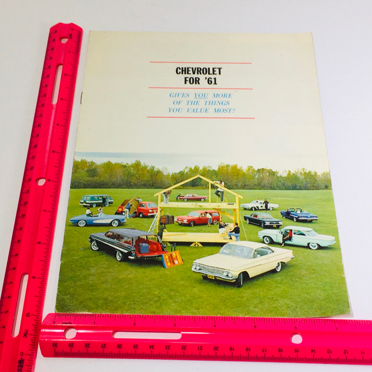 Front cover of the 1961 Chevrolet Chevy Sedan 61PC-3 Dealership Car Auto Brochure Catalog displaying various Chevy models in a promotional setup in a grassy area.