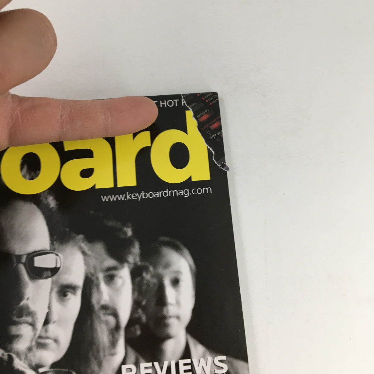 Close-up of Keyboard Magazine August 2005 cover highlighting the edges, featuring Jordan Rudess and reviews of electronic music equipment like the Moog Voyager.