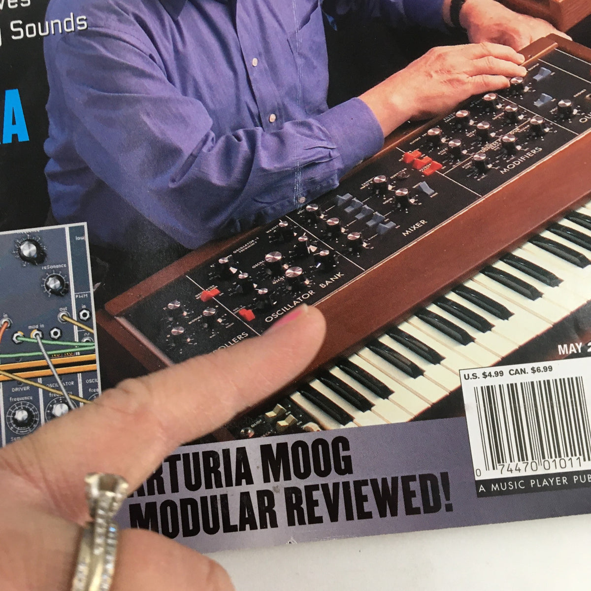 Keyboard Magazine May 2003 cover featuring Arturia Moog synthesizer with a hand pointing at the controls. This issue includes features on electronic music innovation.