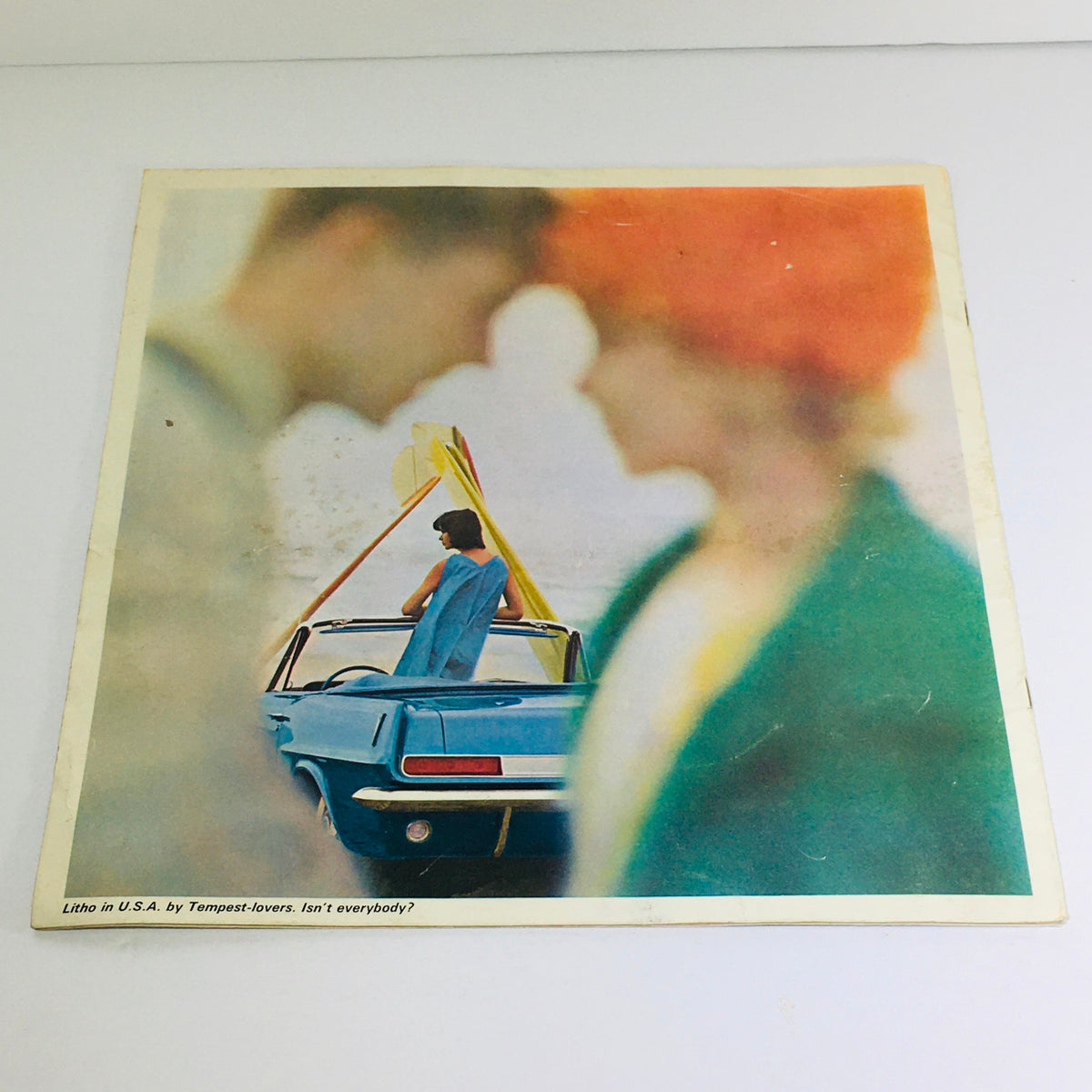 Another angle of the cover of the 1963 Pontiac Tempest brochure, emphasizing the vintage design with a woman by the car and vivid colors.