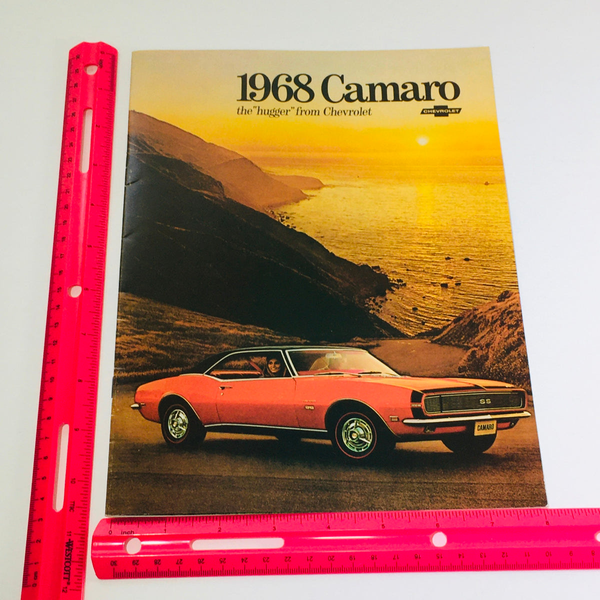 1968 Chevrolet Camaro Showroom Brochure Cover with measurement ruler, emphasizing the iconic 'Hugger' design of the Camaro.