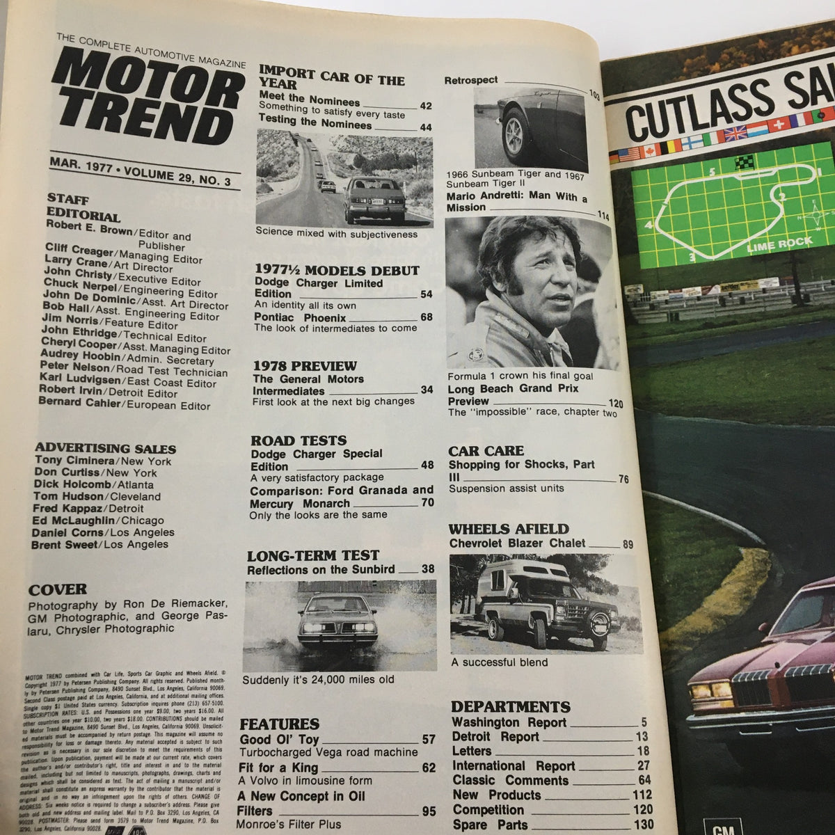 Inside page of VTG Motor Trend Magazine March 1977 featuring articles about the Dodge Charger and Pontiac Phoenix, showcasing automotive industry insights and original advertisements.