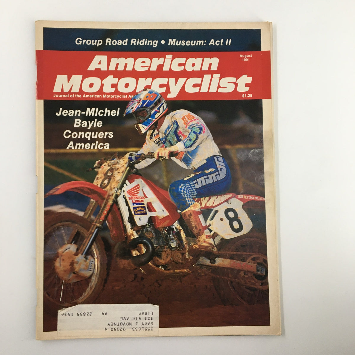 Cover of American Motorcyclist Magazine August 1991 featuring Jean-Michel Bayle conquering America, showcasing motorcycle racing with Bayle in action on track.