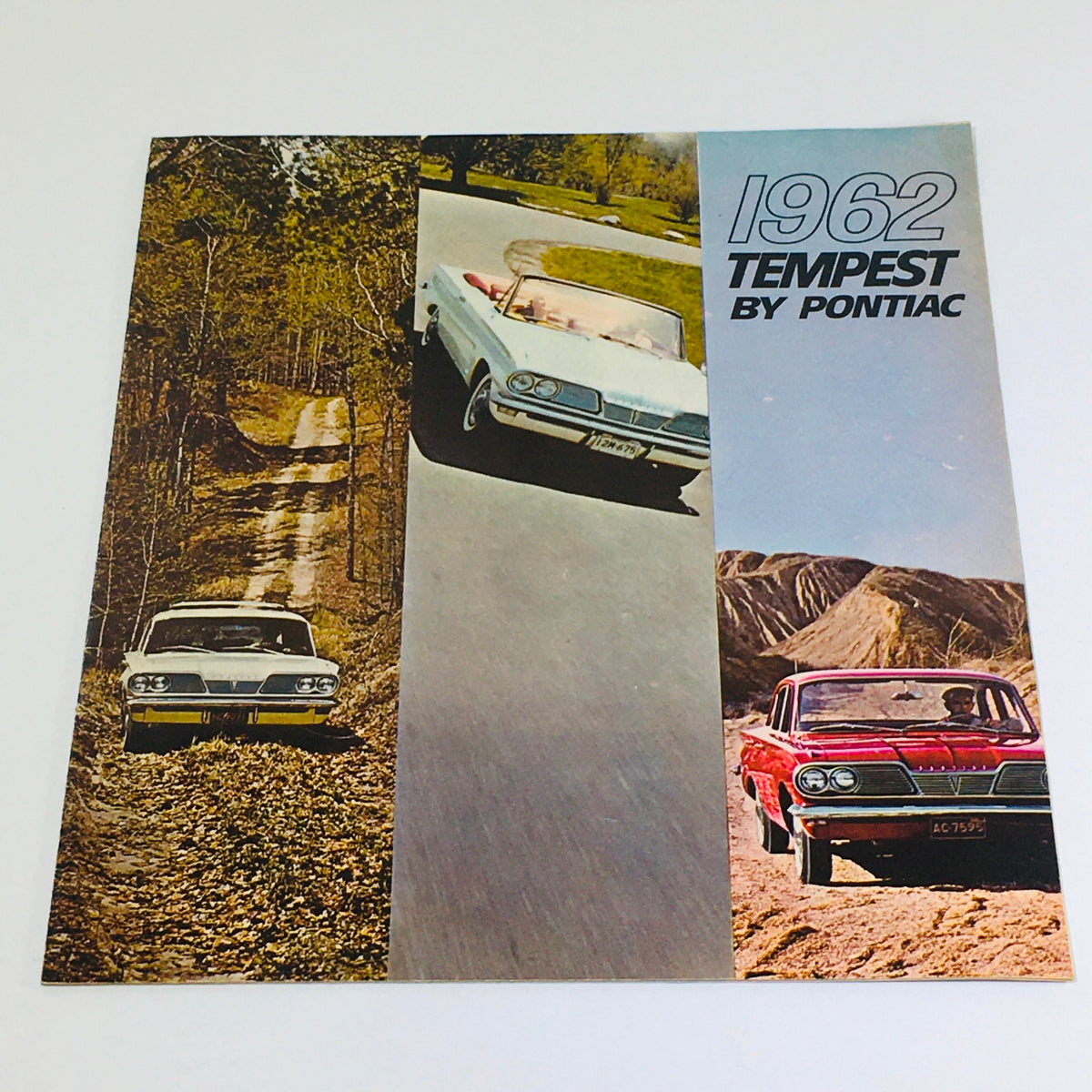 1962 Pontiac Tempest Coupe-Sedan-Wagon Dealership Car auto brochure cover featuring classic vehicles on scenic roads.