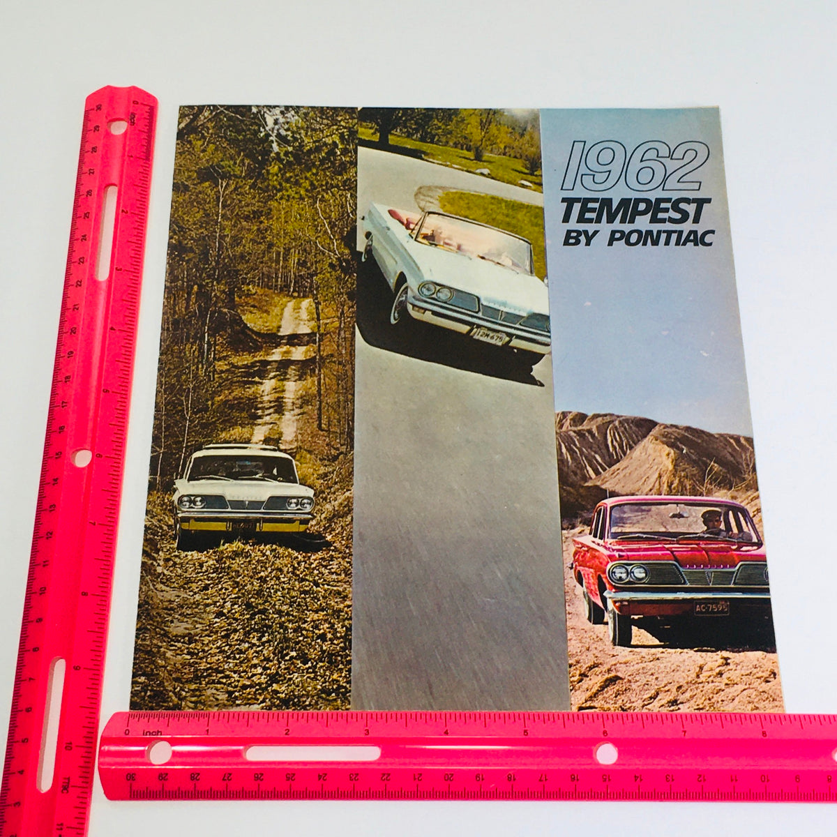 1962 Pontiac Tempest Coupe-Sedan-Wagon Dealership Car auto brochure cover highlighted with a ruler for size reference.