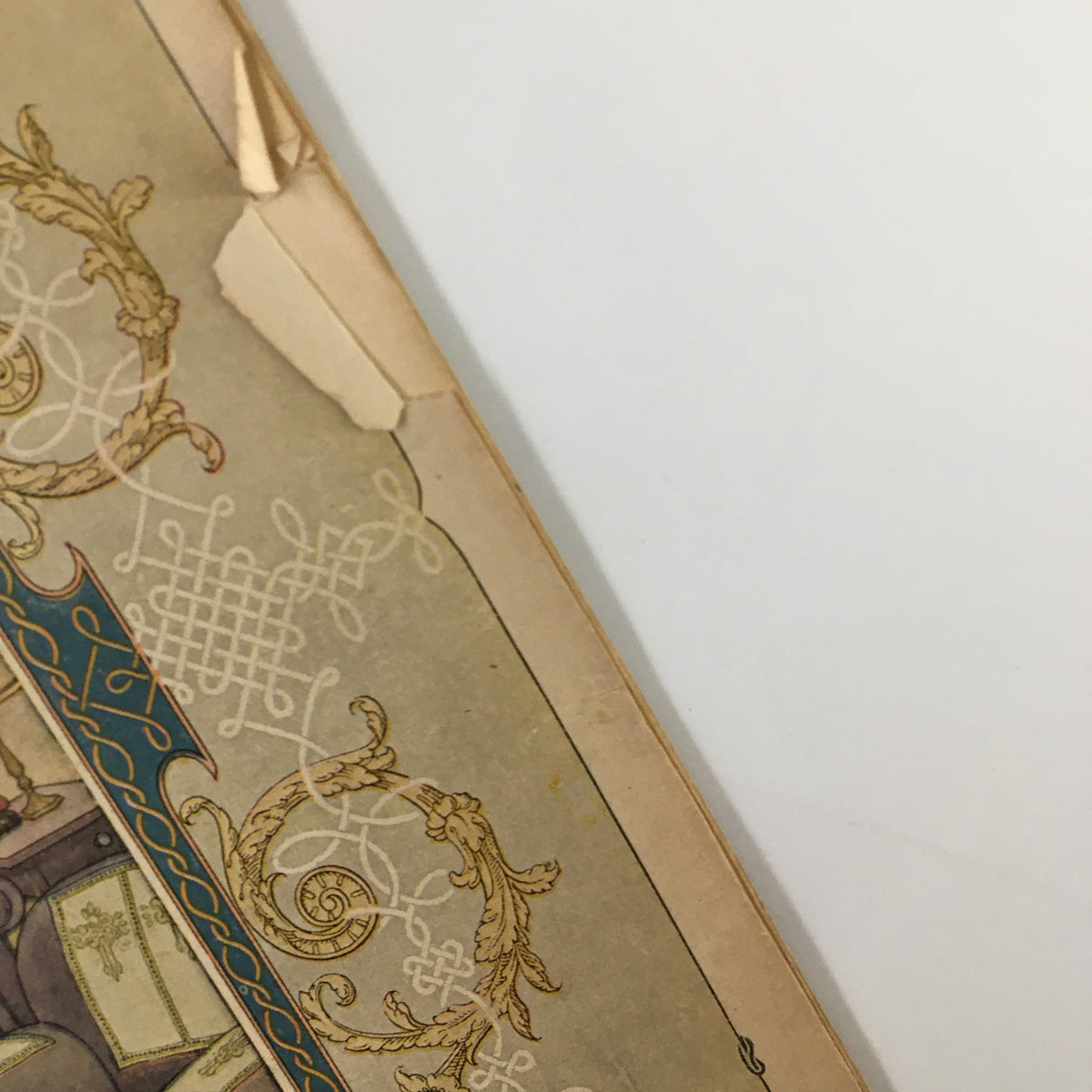 Detail of the cover of VTG Needlecraft Magazine November 1924, highlighting a corner with reinforcing tape and vintage design elements.