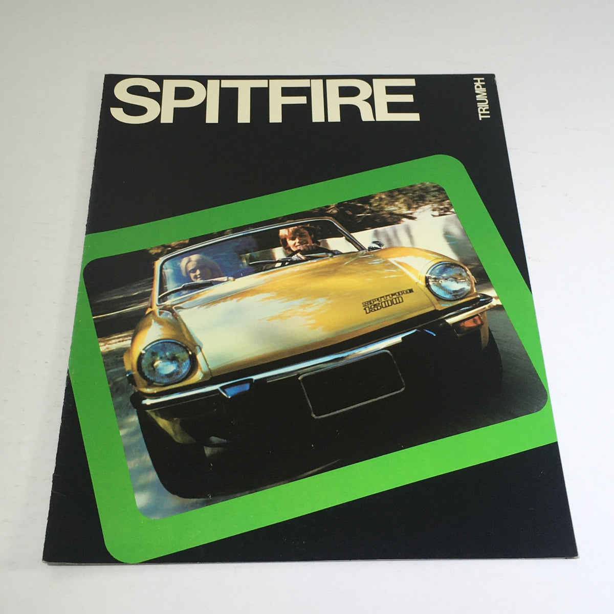 Cover of the 1975 Spitfire Triumph Dealership Specification Car Auto Brochure Catalog featuring a yellow Spitfire model.