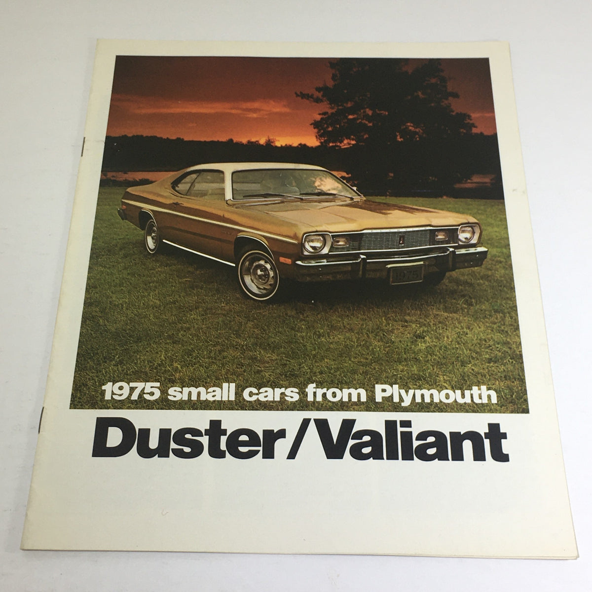 1975 Plymouth Duster Valiant Features Dealership Car Auto Brochure Catalog showcasing a classic bronze Plymouth Duster parked in an outdoor setting.