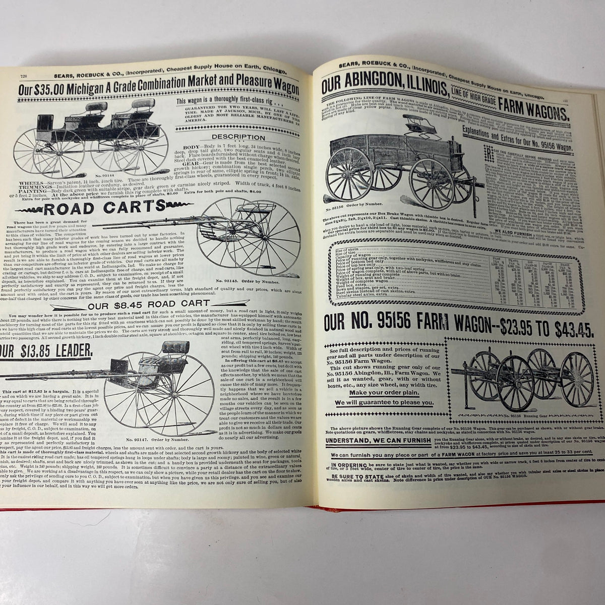 Interior view of the 1897 Sears Roebuck Consumers Guide Hardcover Catalog displaying advertisements for various road carts and farm wagons.