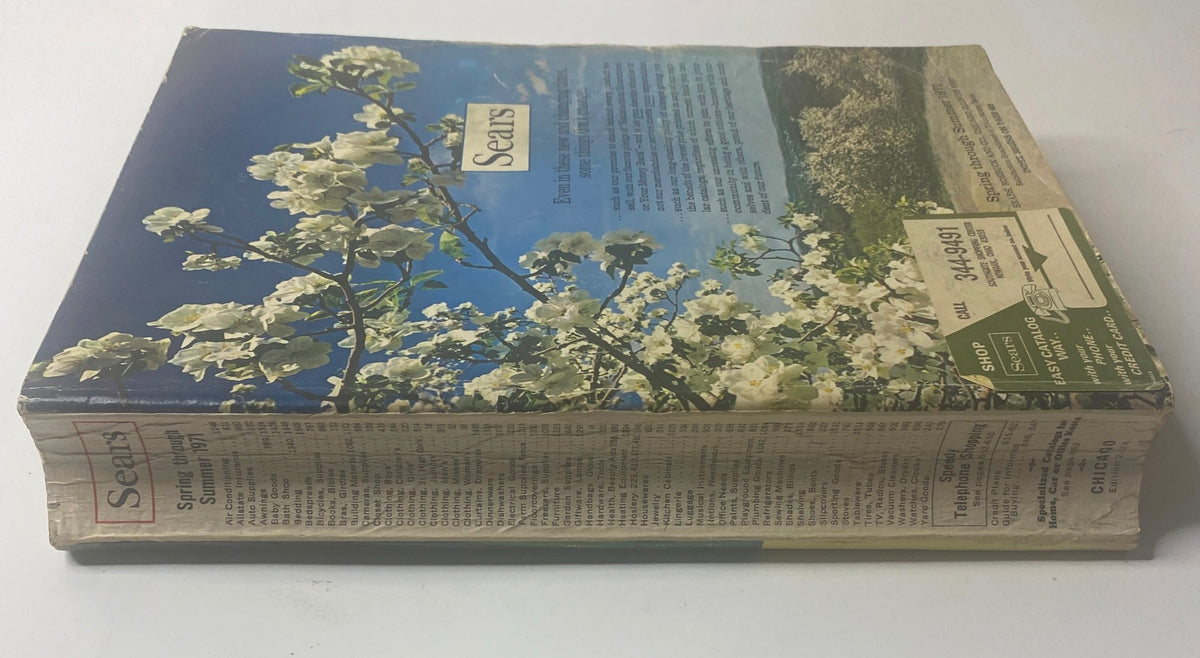 1971 Sears Roebuck and Co. Spring and Summer Catalog featuring a floral cover design with a vibrant blue sky and white flowers.