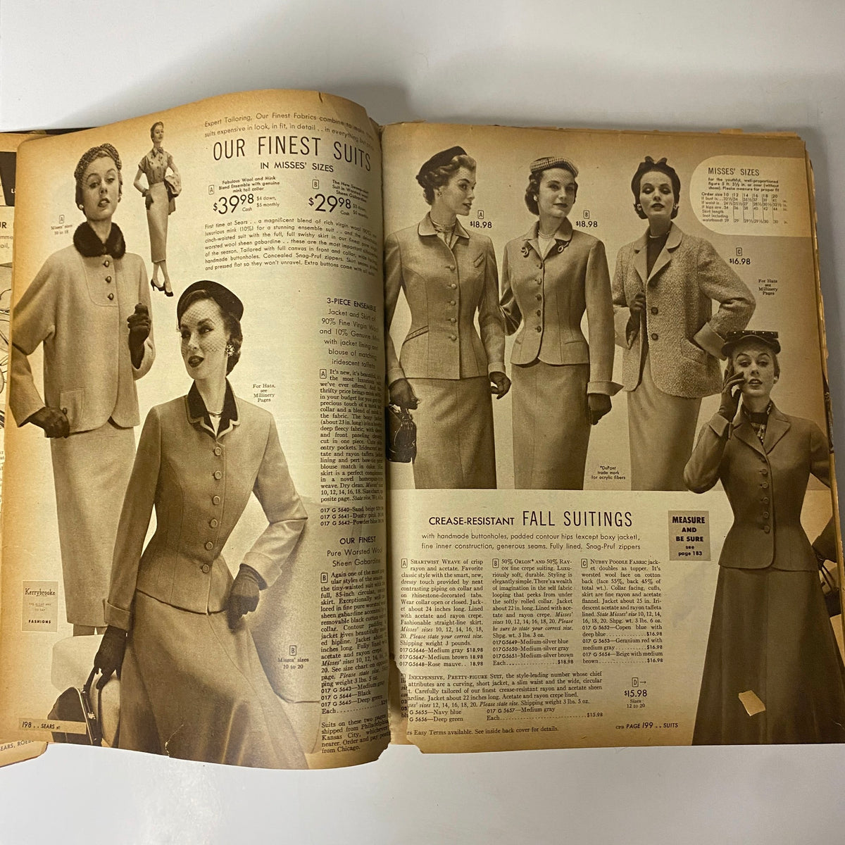 Interior page from the 1954 Sears Roebuck and Co. Fall and Winter Catalog featuring elegant women's suits priced from $29.98 to $39.98 with an array of styles and fabrics.