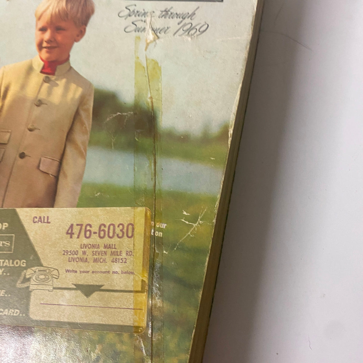 Close-up of the cover of the 1969 Sears Roebuck and Co. Spring and Summer Catalog, highlighting a child's outfit and catalog contact information.