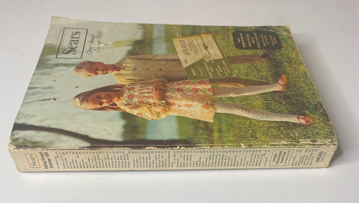 Cover of the 1969 Sears Roebuck and Co. Spring and Summer Catalog, featuring children in vintage clothing standing outdoors, encapsulating mid-century fashion.