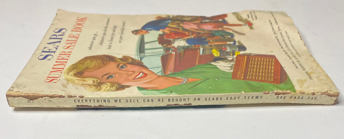 Side view of the 1959 Sears Roebuck and Co. Summer Sale Book Catalog showing wear and tear, highlighting its vintage quality and historical significance.