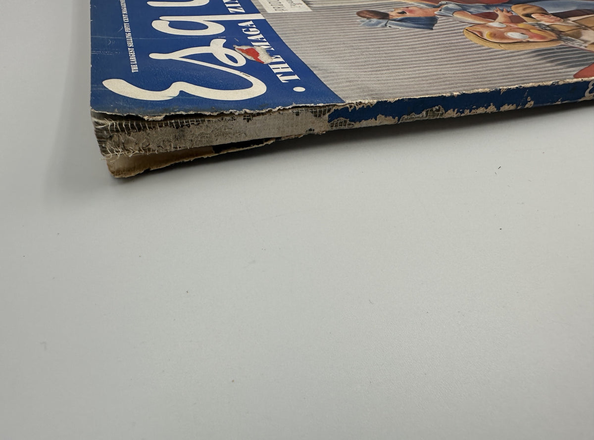 Detailed view of the spine of Esquire Magazine February 1943, displaying signs of age and wear while preserving the iconic Varga Spitfire and pinup imagery.