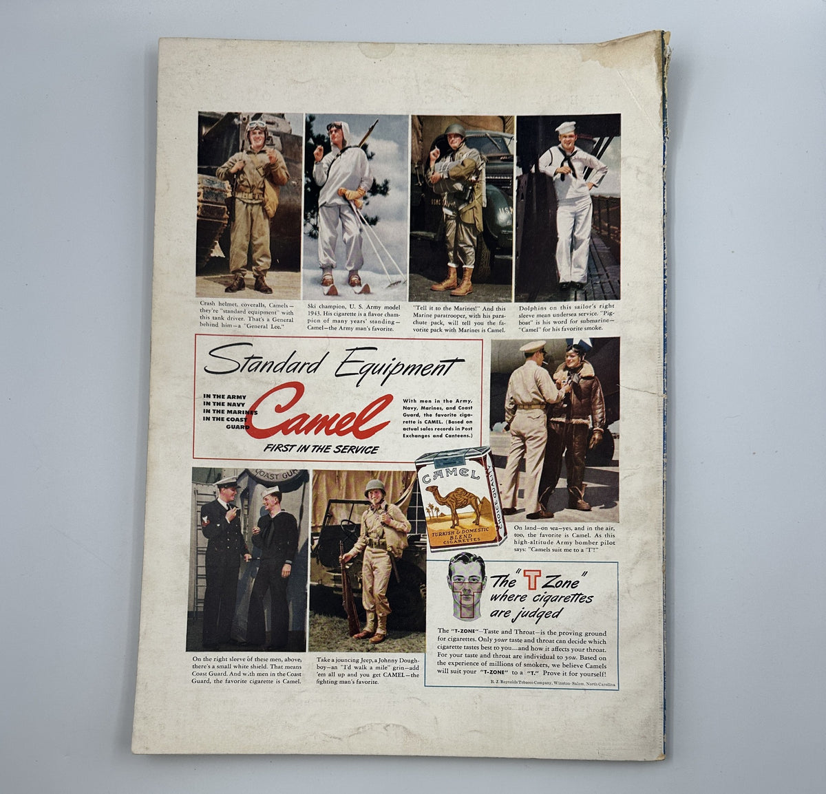Advertisement featuring various military uniforms in Esquire Magazine February 1943, under the title 'Standard Equipment Camel'.