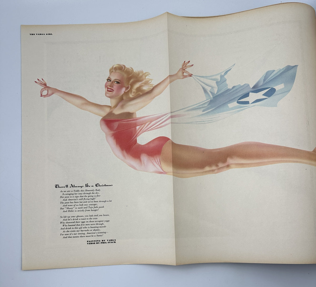 Esquire Magazine December 1943, feature pinup illustration of a blonde woman gracefully flying with a flag, showcasing the Varga artistry for the Christmas issue.