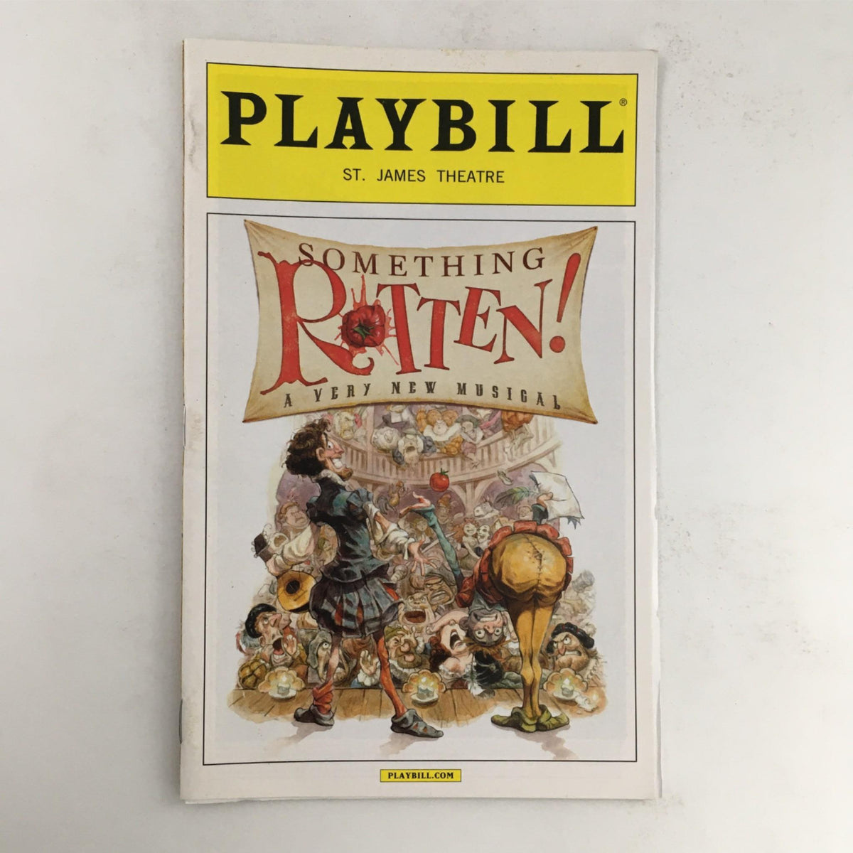 2015 Playbill for Something Rotten, a musical by Christian Borlen, featuring colorful artwork depicting whimsical characters from the show, published at St. James Theatre. The Playbill is in good condition and comes with protective covering.