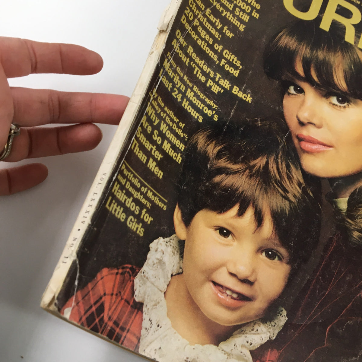 Close-up view of the Ladies' Home Journal Magazine, November 1967 issue cover showing a woman and a child, showcasing the magazine's aged condition with slight damage.