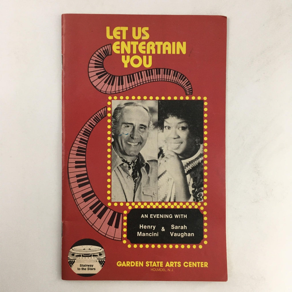 1980 An Evening with Henry Mancini & Sarah Vaughan at Garden State Arts Theatre, featuring a vibrant red program cover displaying images of Mancini and Vaughan against a musical background.