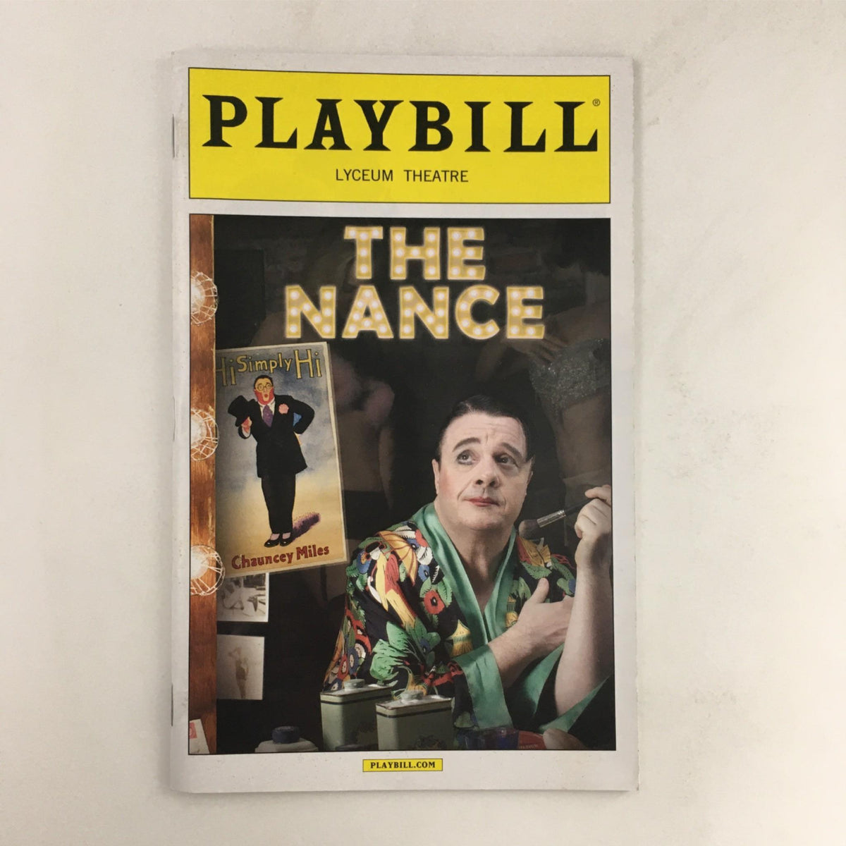 2013 Playbill for The Nance featuring a character portrait, highlighted with theatrical lighting, from the production directed by Jack O'Brien at Lyceum Theatre.